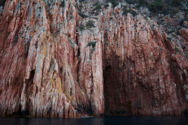 rock formations in the mountains at dusk by a river