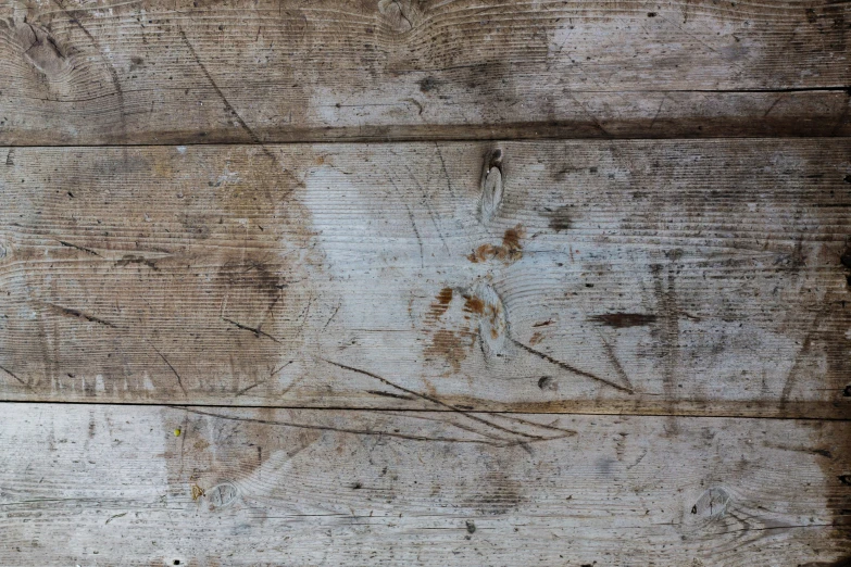 a piece of wood that is brown and white with peeling paint