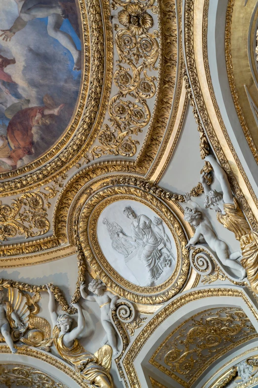 a painting on the ceiling and a clock is in view