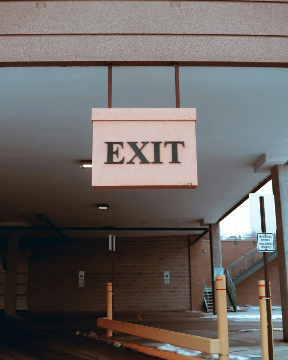 there is an exit sign hanging over the entrance