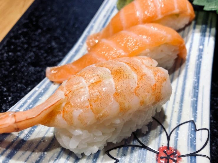 a plate with rice and a pair of shrimp sticks