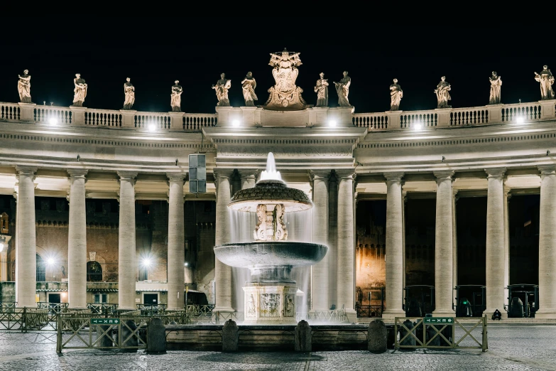 a building with pillars and lights around the entry