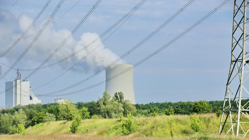 power lines are flying from the smoke stacks above power plants