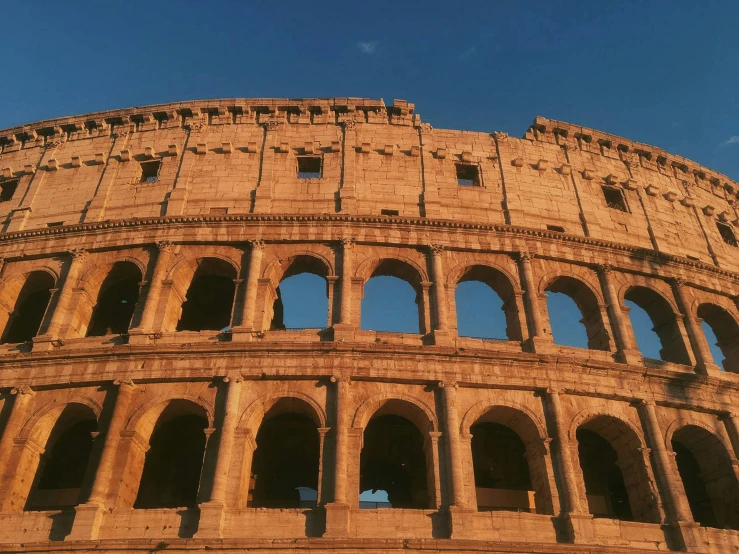 the colliseum is brown, and there are two arches that look to be cut out