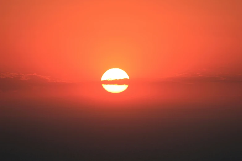 an airplane that is flying by the sun in the sky