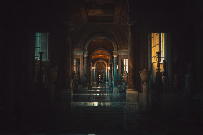 a large hallway in a dark building with lights at night