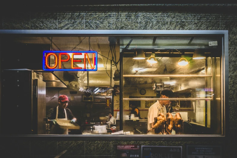 a man sitting inside of a restaurant window