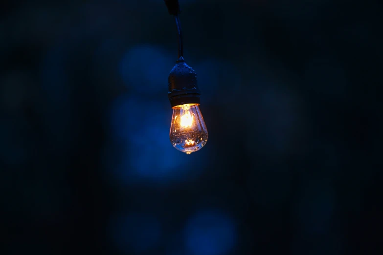 a light bulb is lit up in the dark