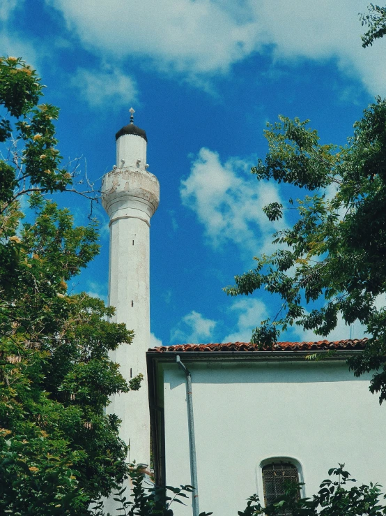 an islamic style building sits amid trees