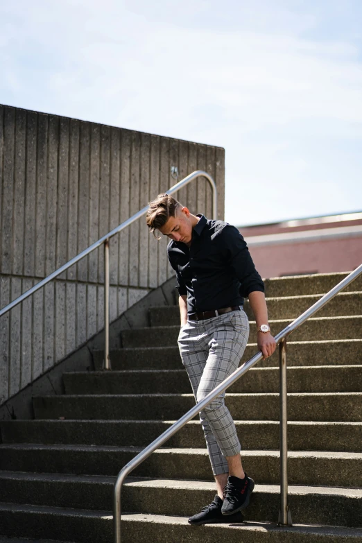 a man walks up some stairs while holding a baseball bat