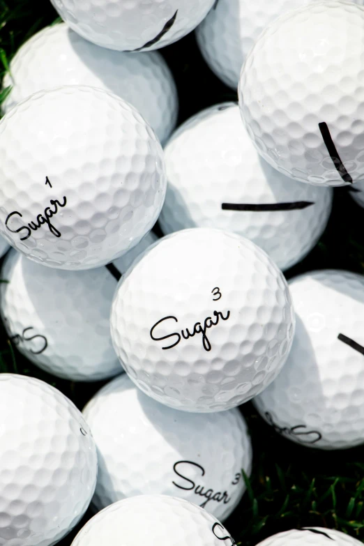 a bunch of white golf balls with marker marks on them