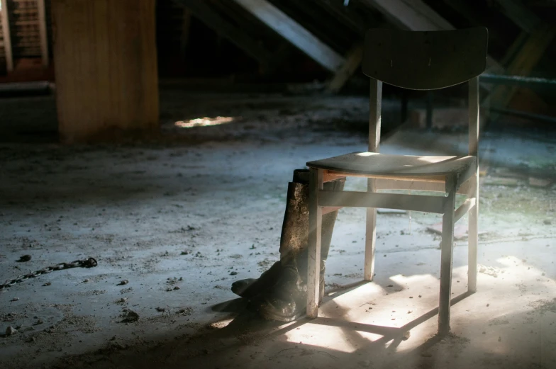 the chair is sitting alone by itself in the dark