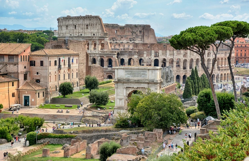 a bunch of people stand outside a roman city