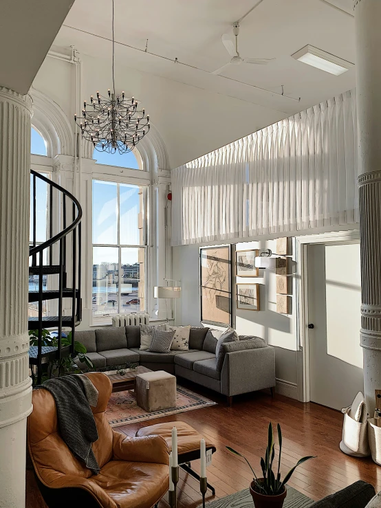 a living room with wood flooring and white walls