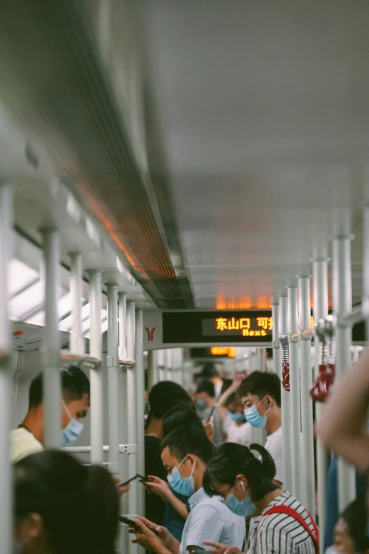 several people sitting down and looking at their cell phones