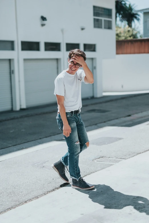 a young man skateboarding on the sidewalk