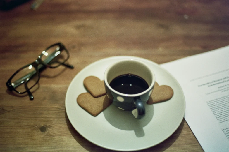 a cup of coffee sits next to some papers