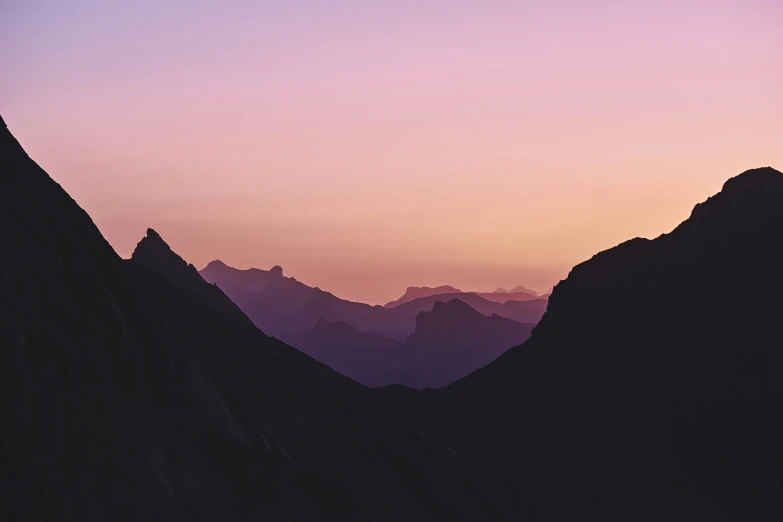 silhouette of mountains with a hazy sky in the distance