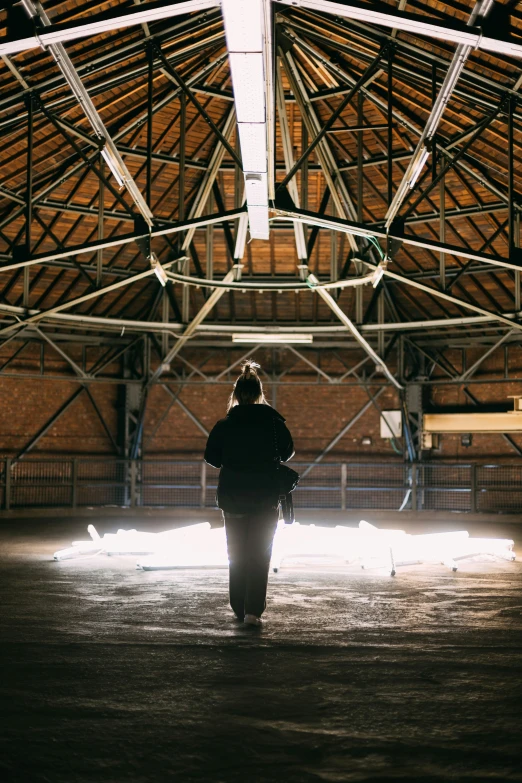 a person standing in a large room with scaffolding