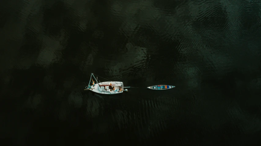 two boats in the dark waters at night