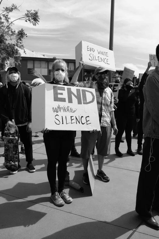 some people holding signs and protesting outside a building