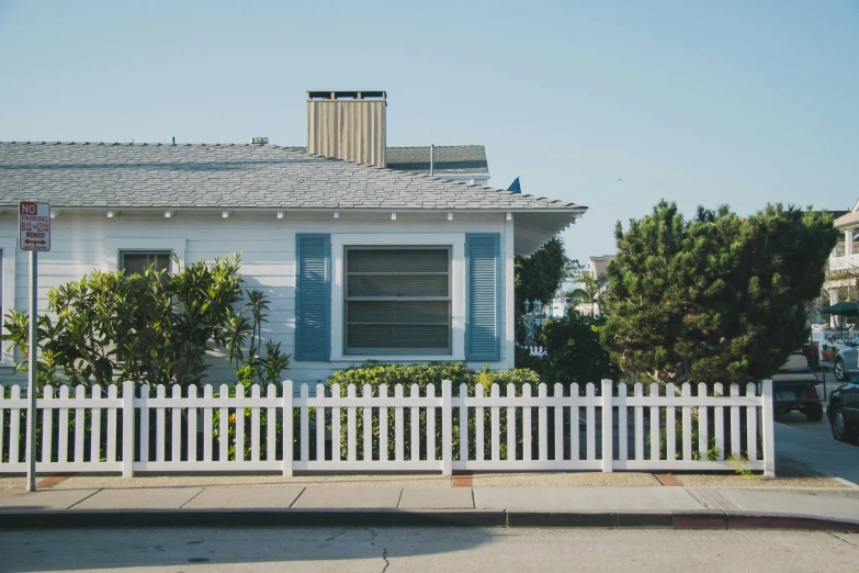 a white picket fence next to a house