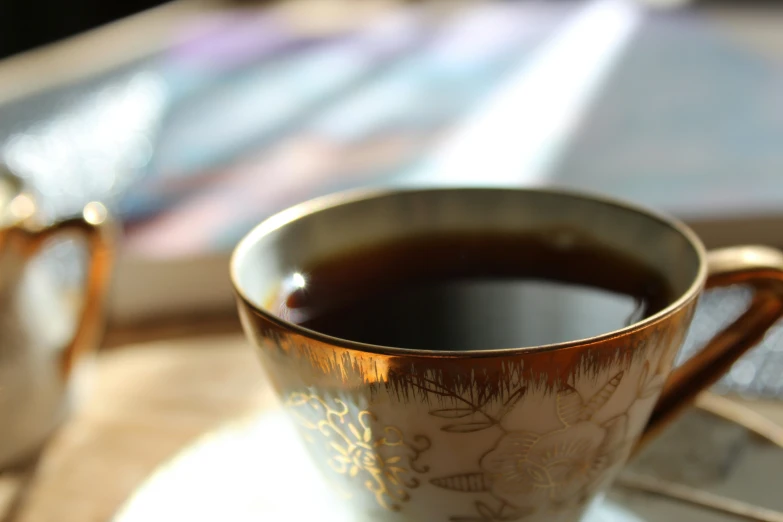 an espresso cup sitting on a plate on top of a table