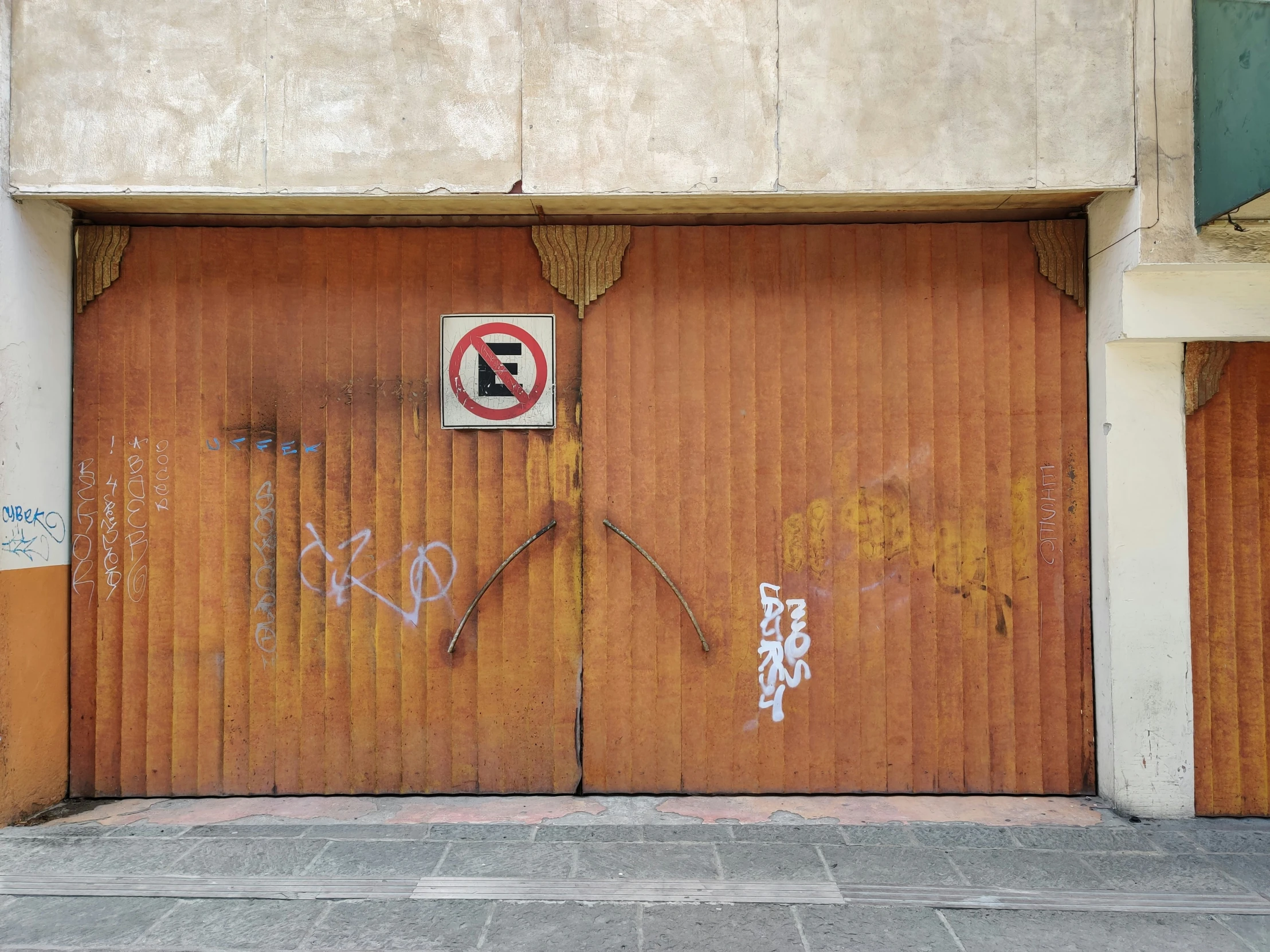 a garage door with graffiti on it and two fire hydrants