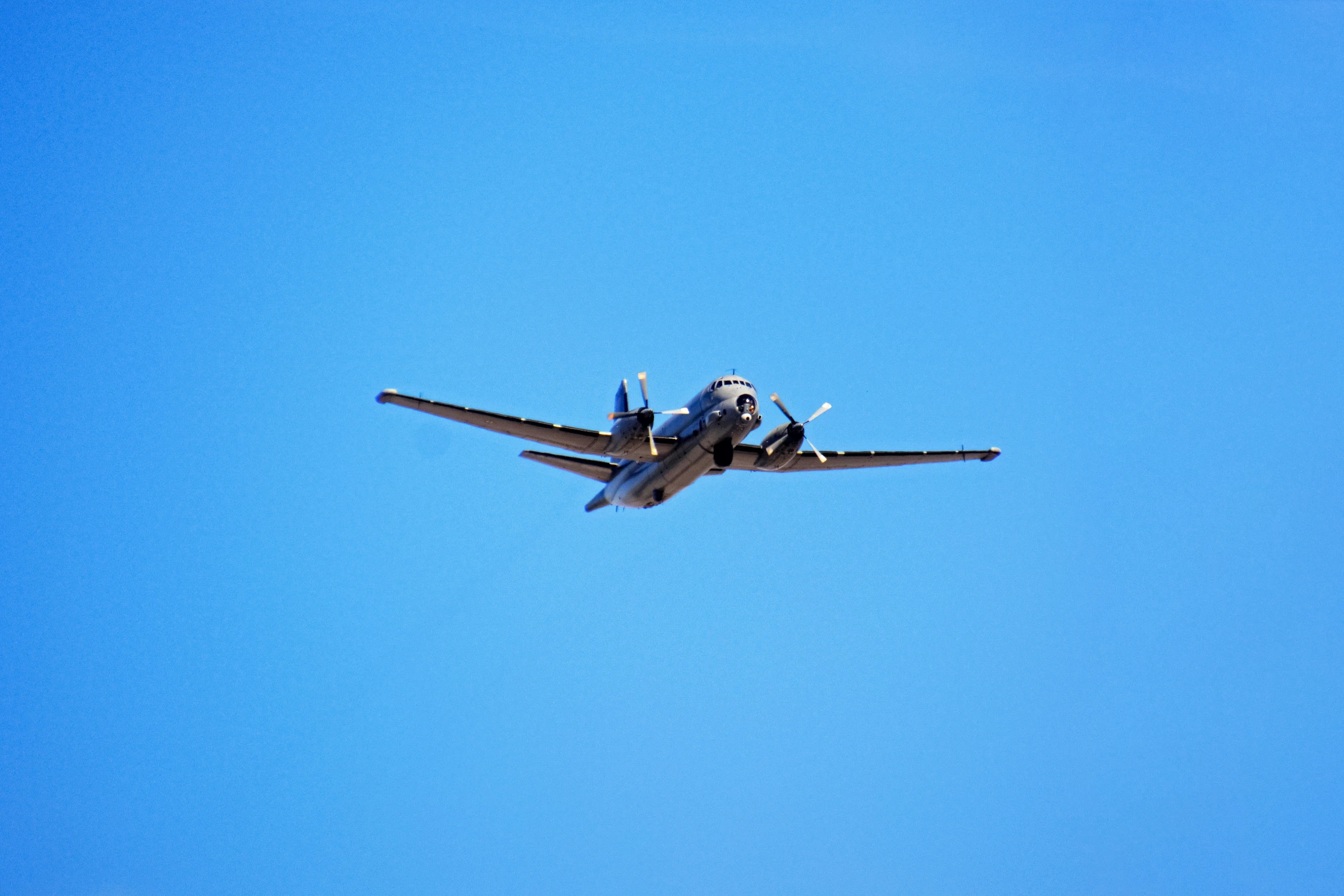 a small airplane flying thru a clear sky