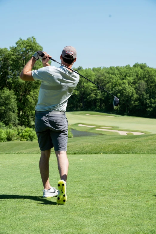 a man hitting a golf ball with a golf club