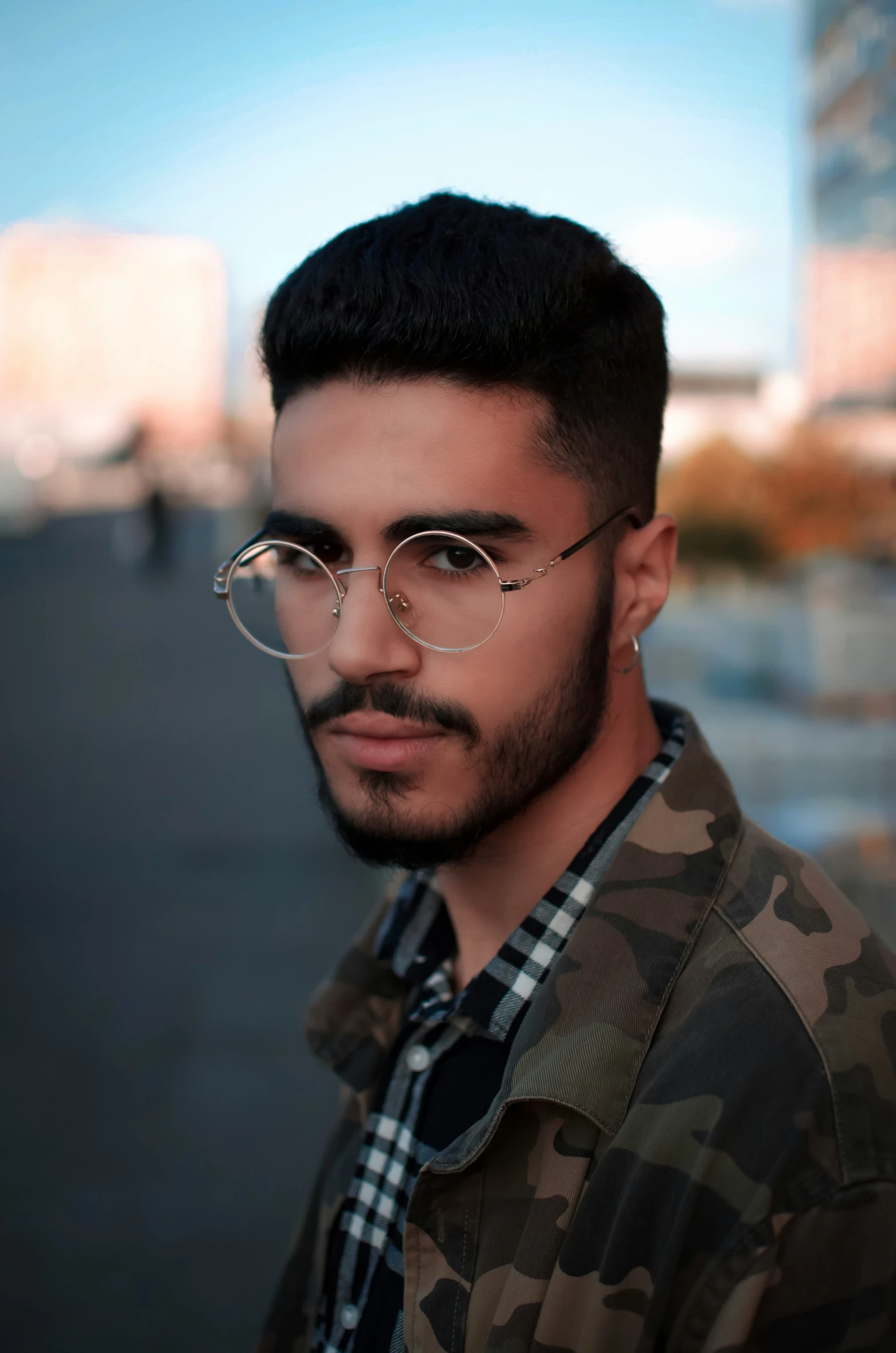 a man with glasses on his head posing for the camera