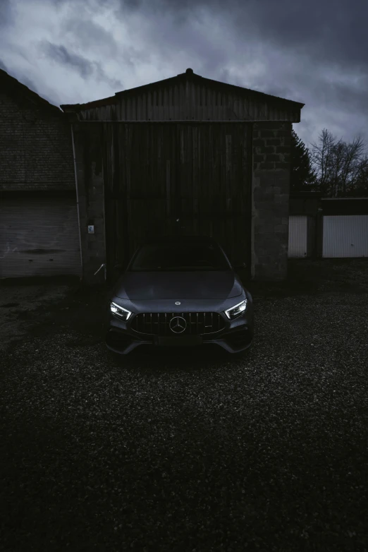 a car parked in a driveway under a dark sky