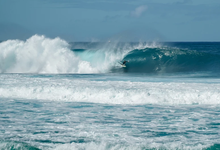 man riding a wave in the ocean on a surf board