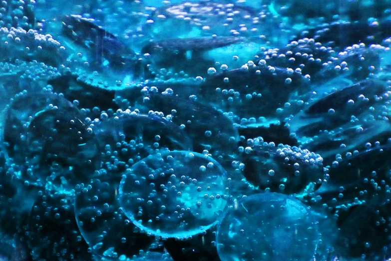 this is a closeup of a glass with bubbles and water on it