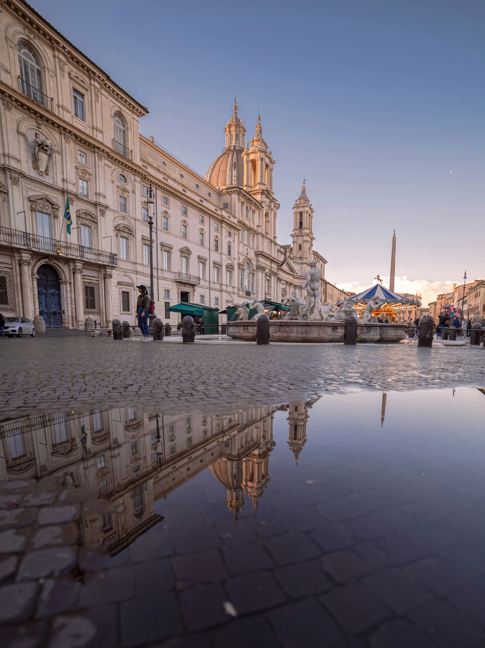 the sun sets on a city square with no people