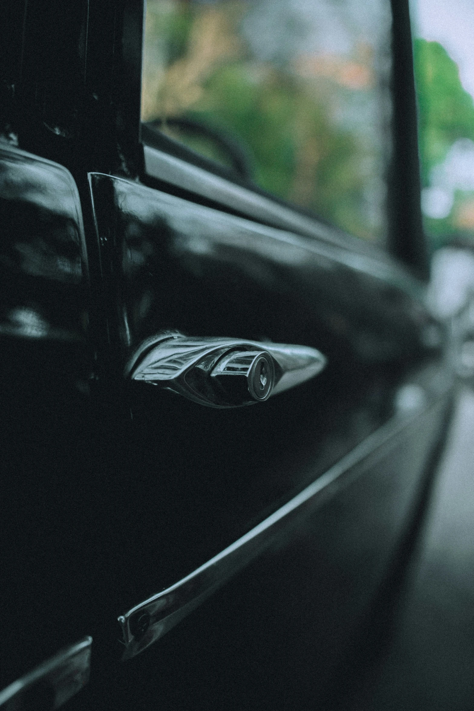 the view of a car door and outside with windows open