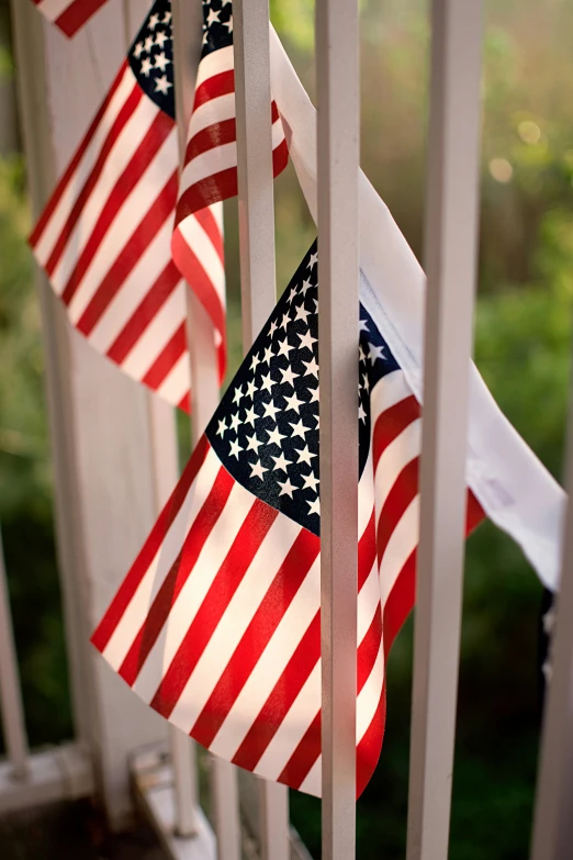 three american flags hung on the side of a door