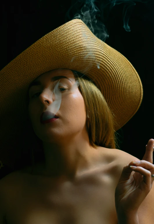 a girl wearing a hat and smoking a cigarette