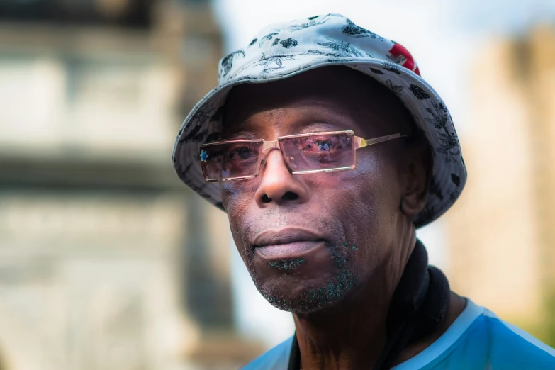 an older man wearing glasses and a hat on