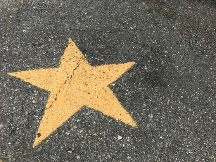 a yellow and white star with a black background