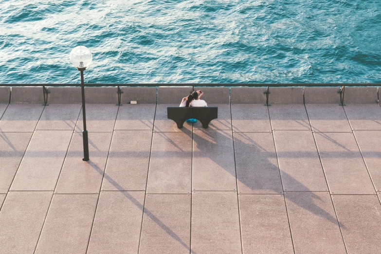 a person sitting at a laptop on the beach