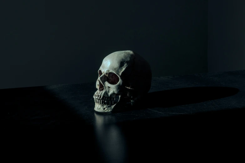 an evil looking skull on a black surface