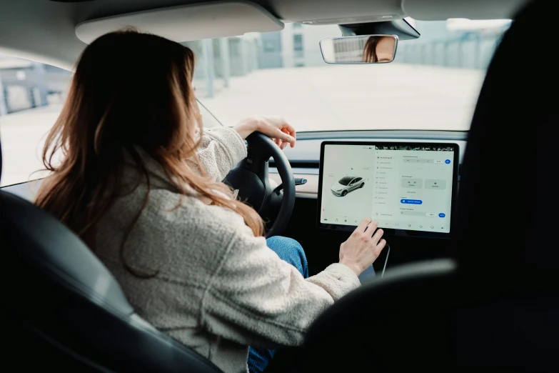 woman sitting in the back seat of a car driving