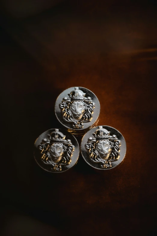 three sets of gold and silver plates with decorative crest design