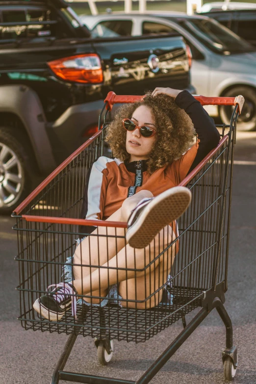 the girl is relaxing in the shopping cart