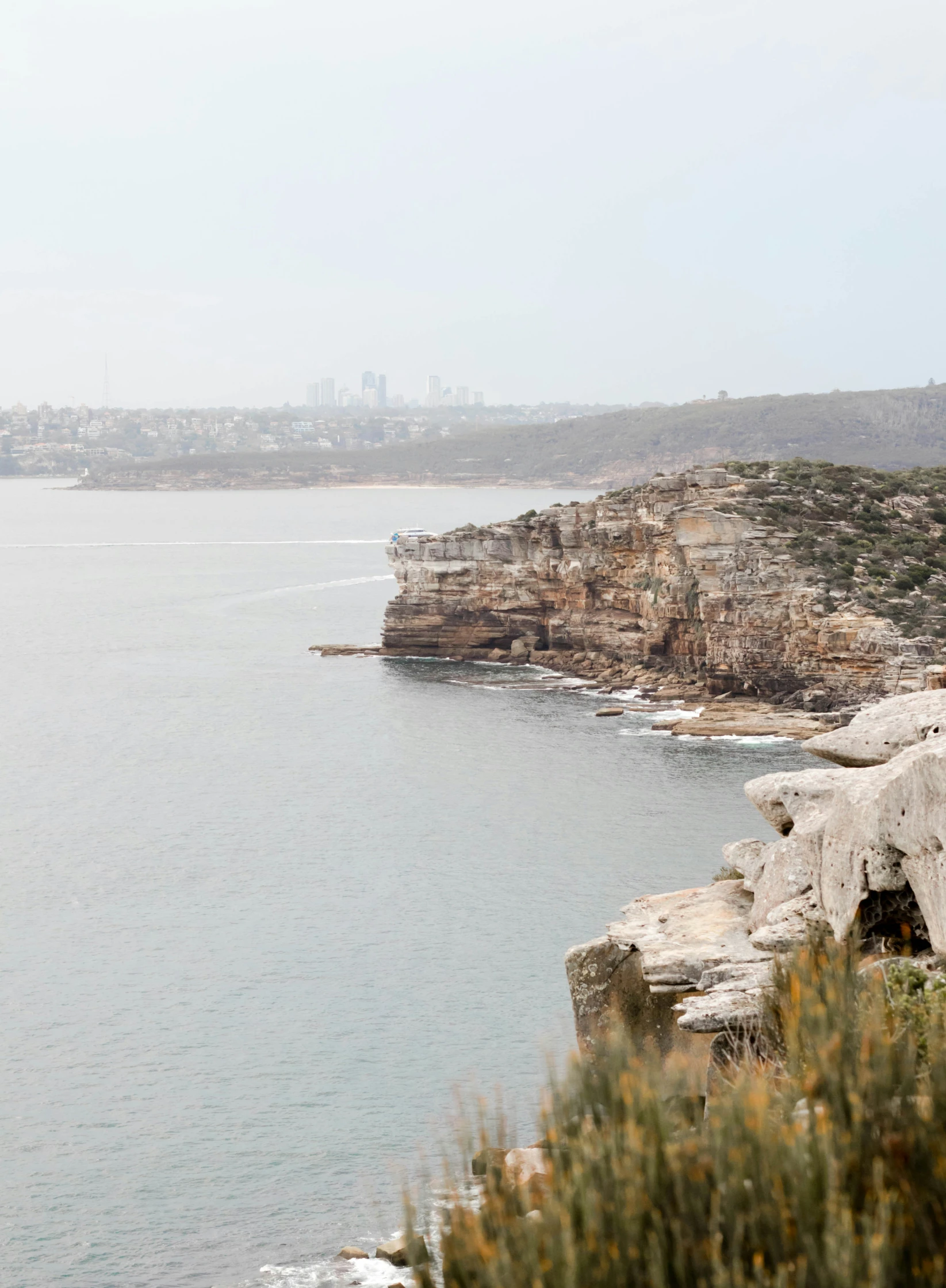 a group of rocky shorelines next to a large body of water