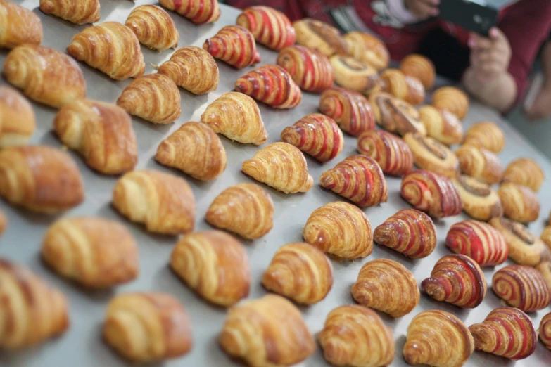 an array of croissants and other pastries displayed