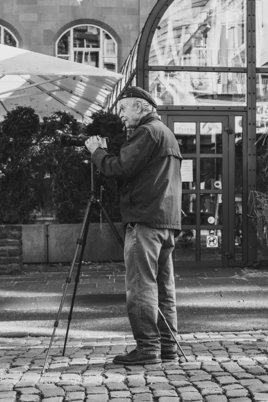 a man on the sidewalk holding an umbrella in his hands