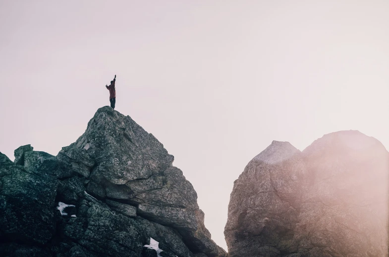 there is a person that is standing on top of a rock