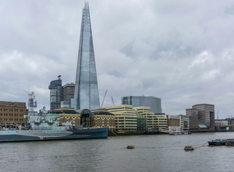 a large ship next to a large tower in the city